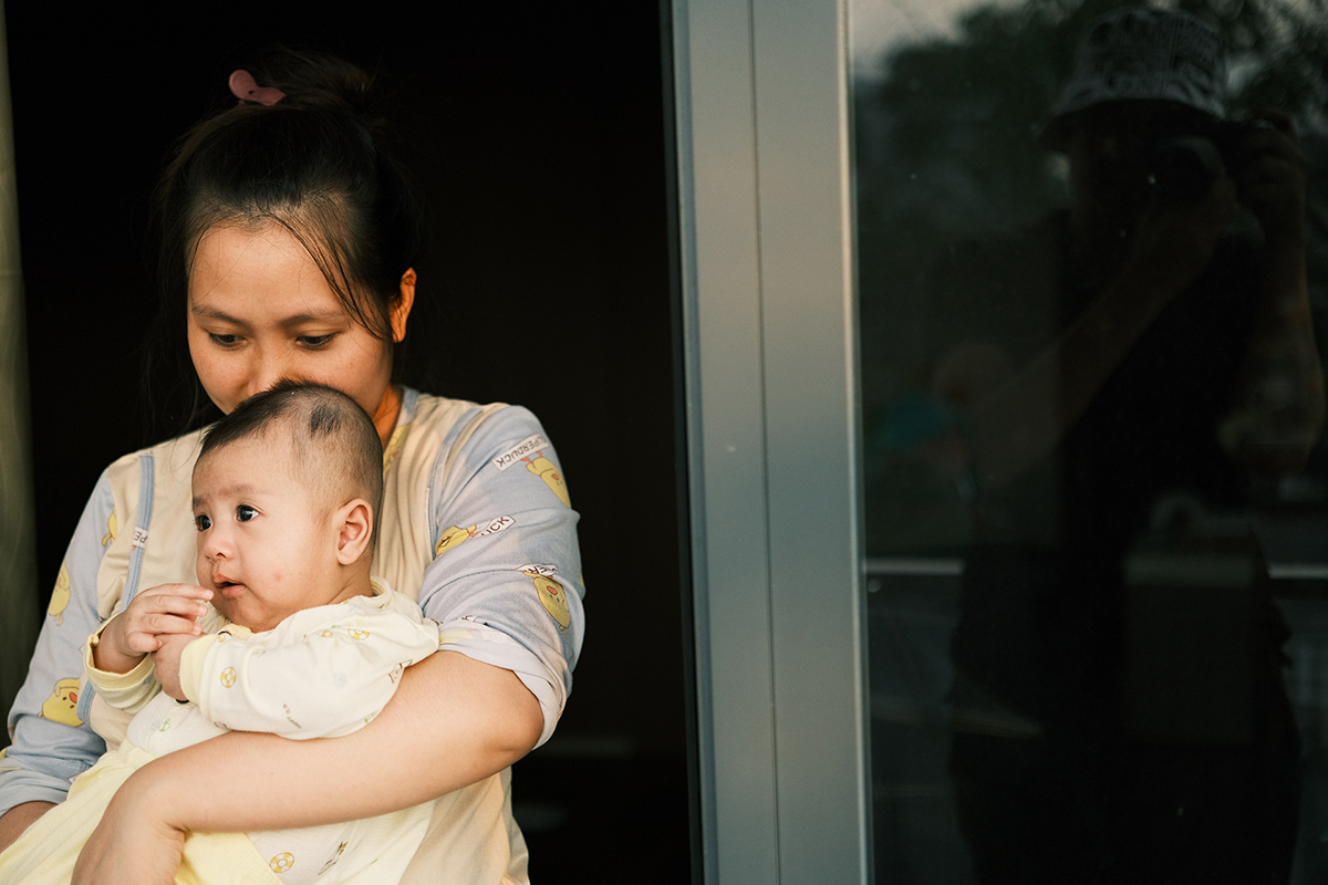 Vietnamese mother with alert baby in arms, illustrating "Things My Mother Didn't Tell Me" at Third Eve